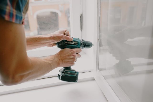 person repairing a window